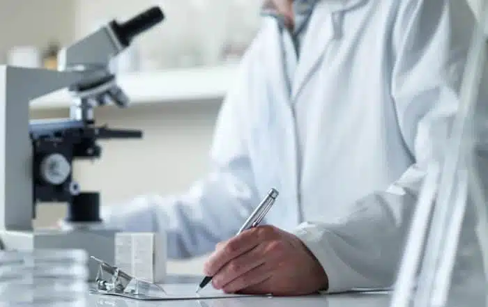 scientist conducting research with microscope selective focus