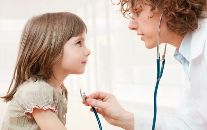 Female mature doctor examining little girl - closeup leucovorin and acetaminophen