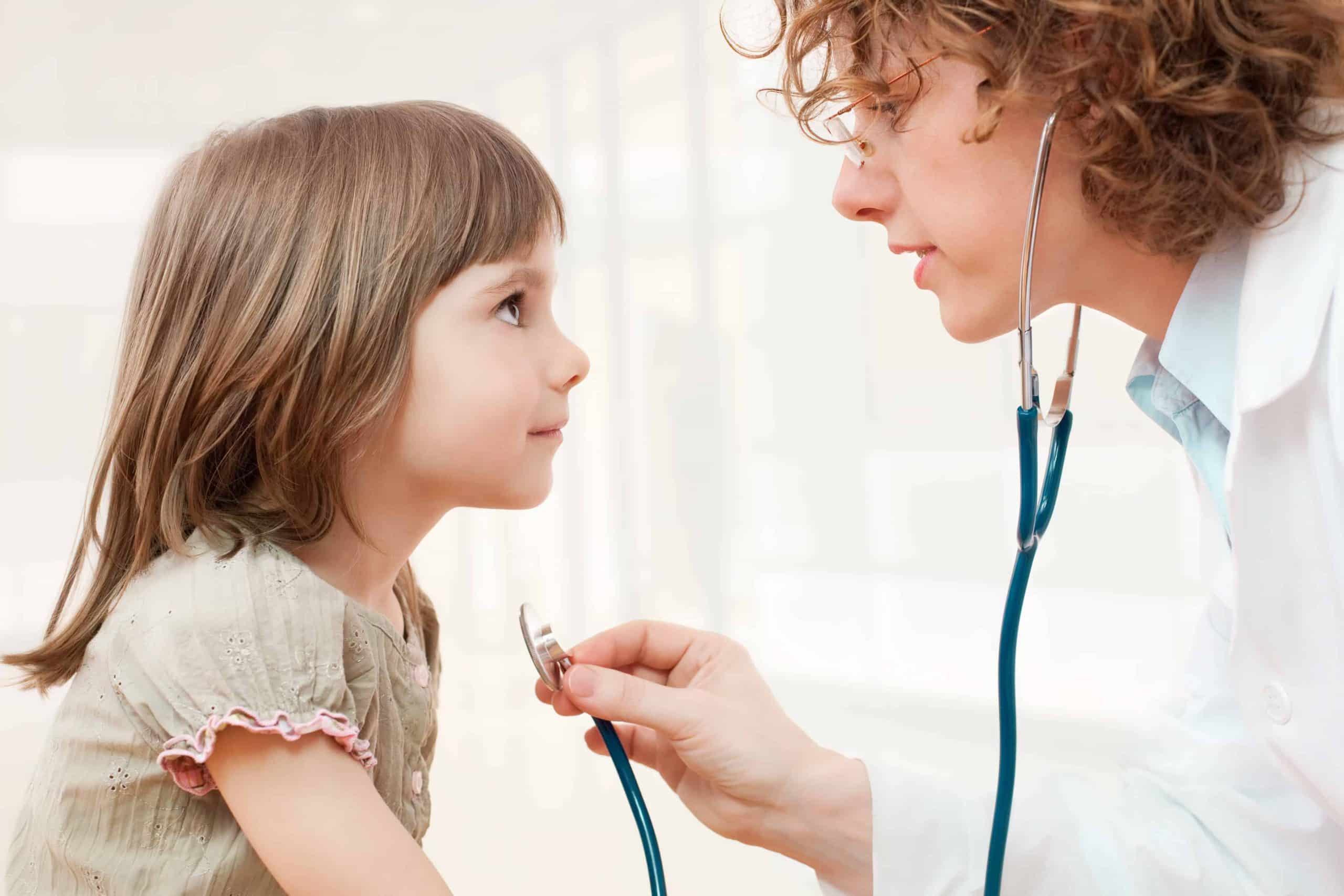 Female mature doctor examining little girl - closeup leucovorin and acetaminophen