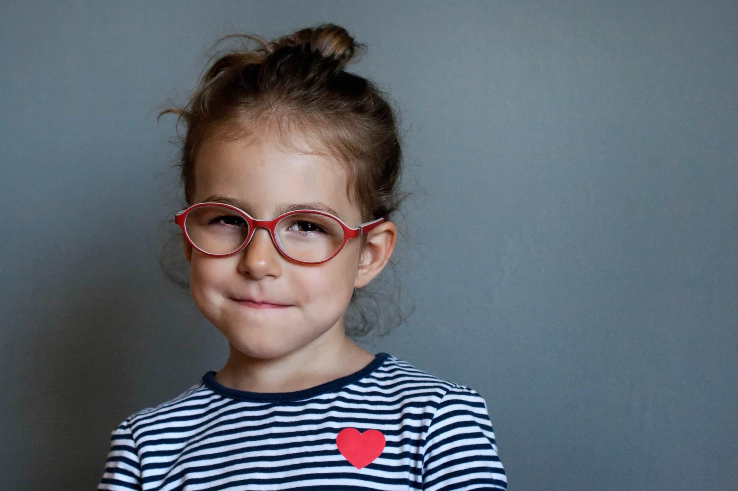 A little girl with red glasses
