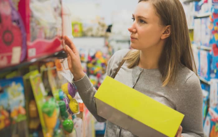 Woman choosing toy in a children's store.
