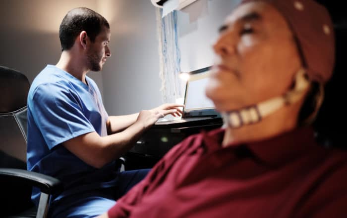 Elderly male patient with Alzheimer's illness, undergoing electroencephalogram examination Senior man with a nurse in clinic for medical evaluation using EEG. Brain illness prevention using technology