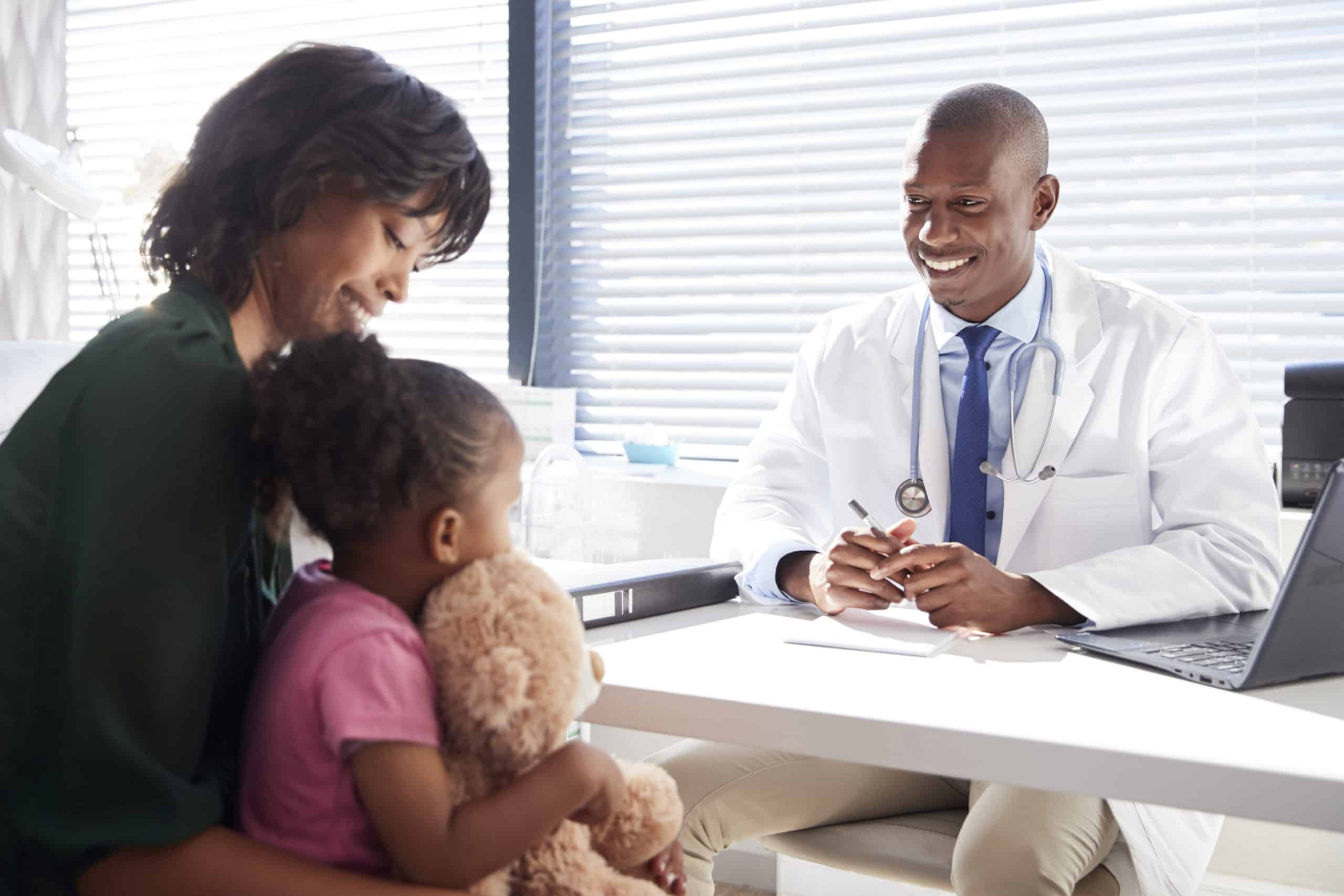 Happy mom and child smiling during a visit to the doctor's office