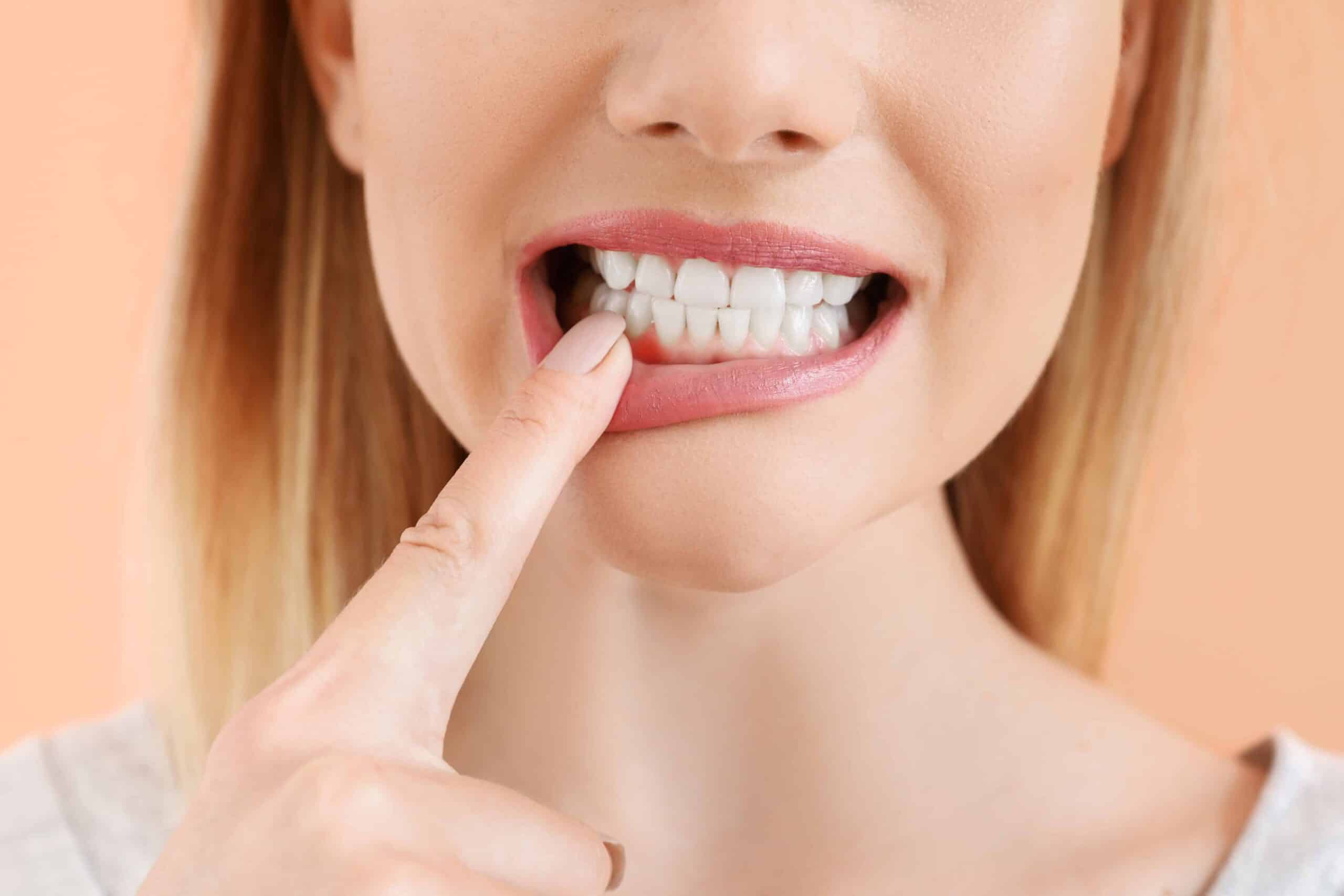 Beautiful woman with healthy teeth on color background, closeup Woman with healthy teeth closeup