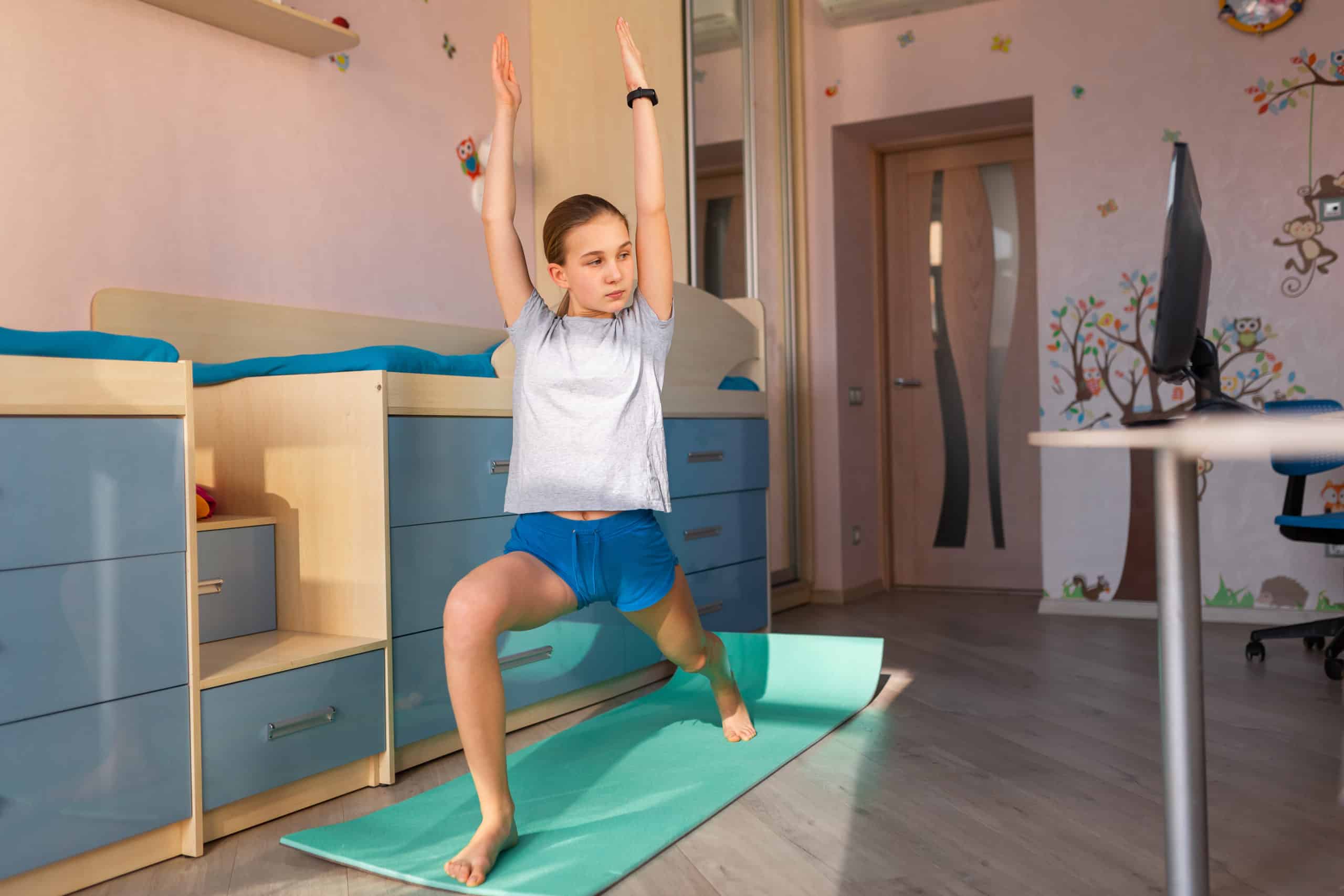 Tennage girl doing fitness gymnastics at home