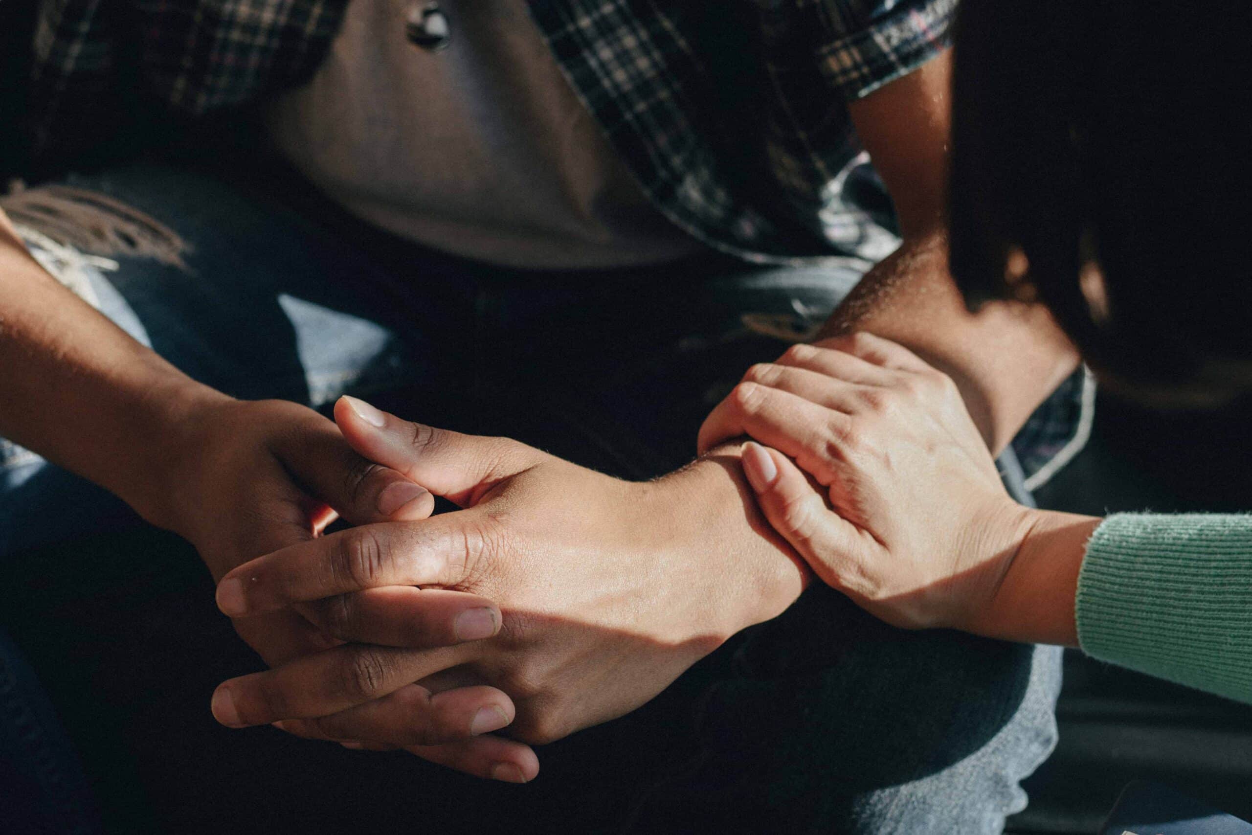 Close-up of a woman supporting a man, showing care and assistance
