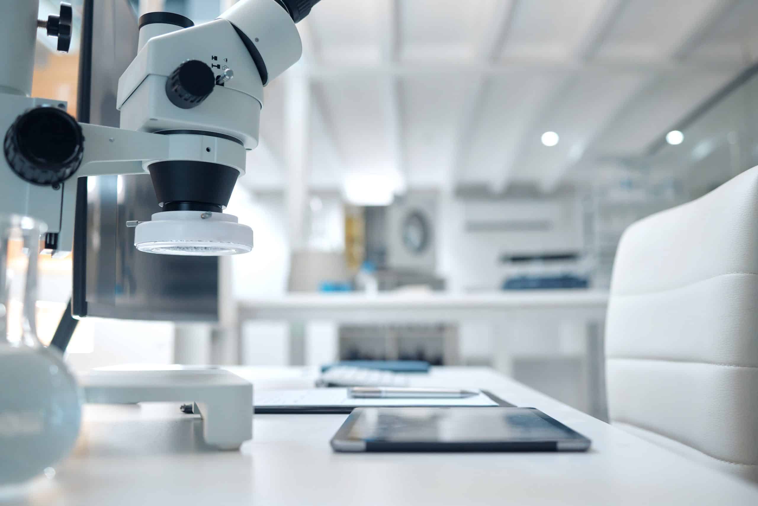 Science, laboratory and microscope with tablet for research, medical study and vaccine development. Healthcare, biotechnology and desk with digital tech and machine for analytics, experiment and test