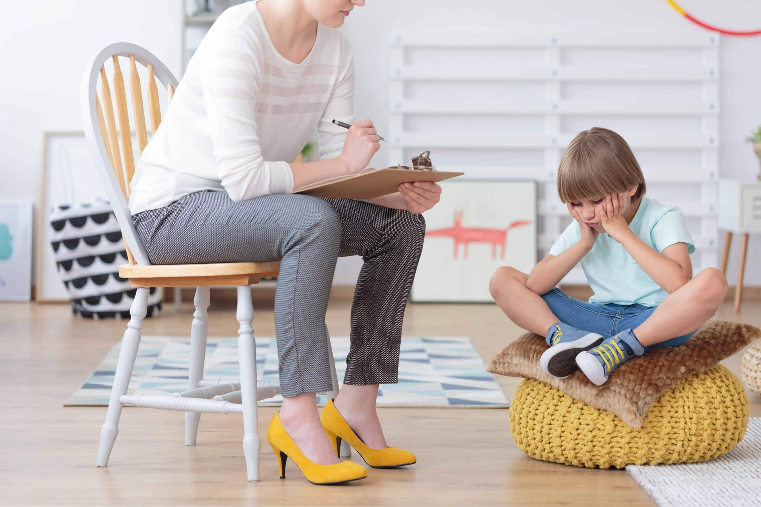 Children anxiety and depression concept, psychologist talking with sad little boy at the office