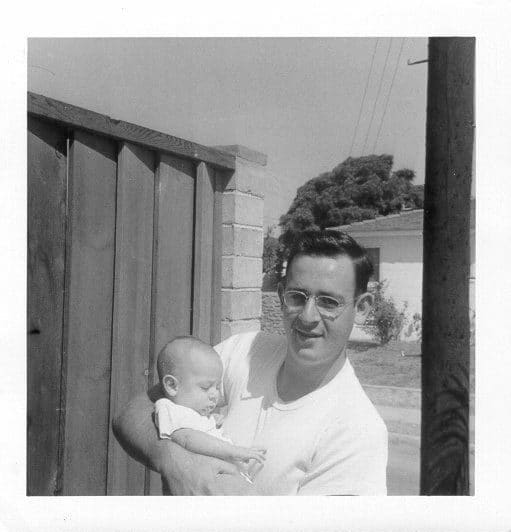 Baby Mark with Bernie Man holding a baby outside in front of a house