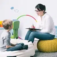 Teacher and kid interacting in the daycare