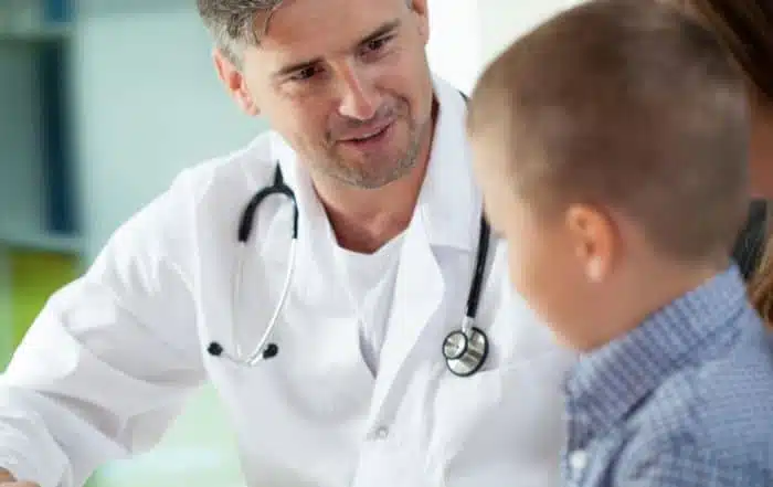Doctor talking to a child during a check-up