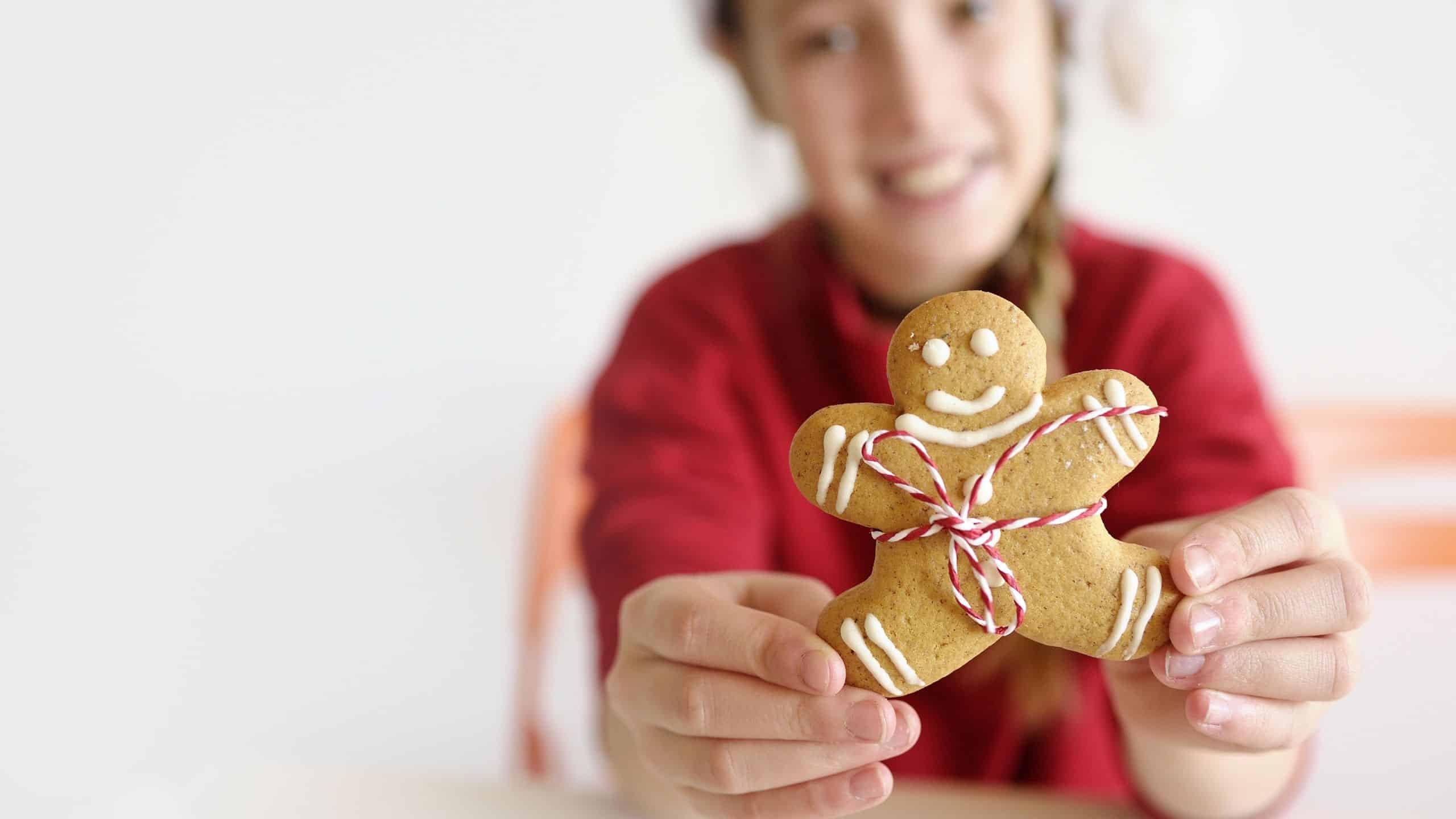 Girl holding gingerbread cookie