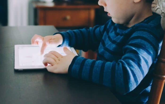 Close-up of a kid playing on an iPad