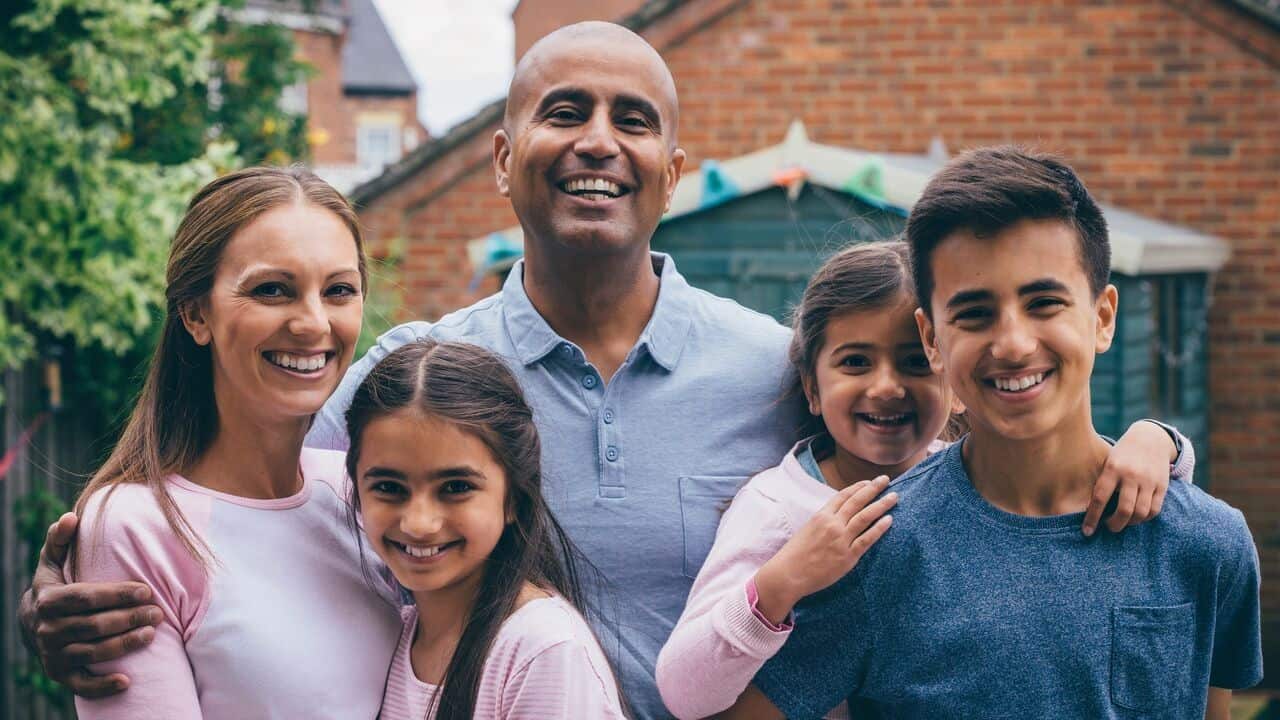 Smiling family of five standing for a group picture