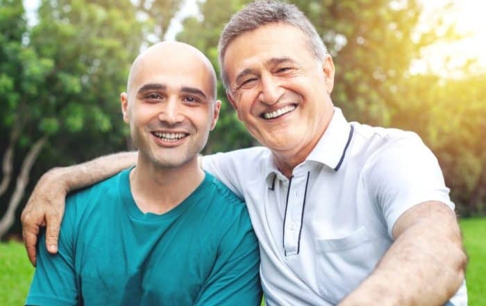 Two people sharing a hug and smiling