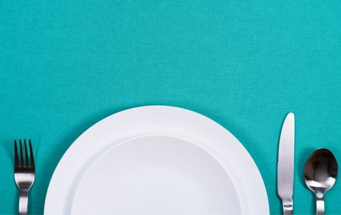 Plate and cutlery set on a blue background