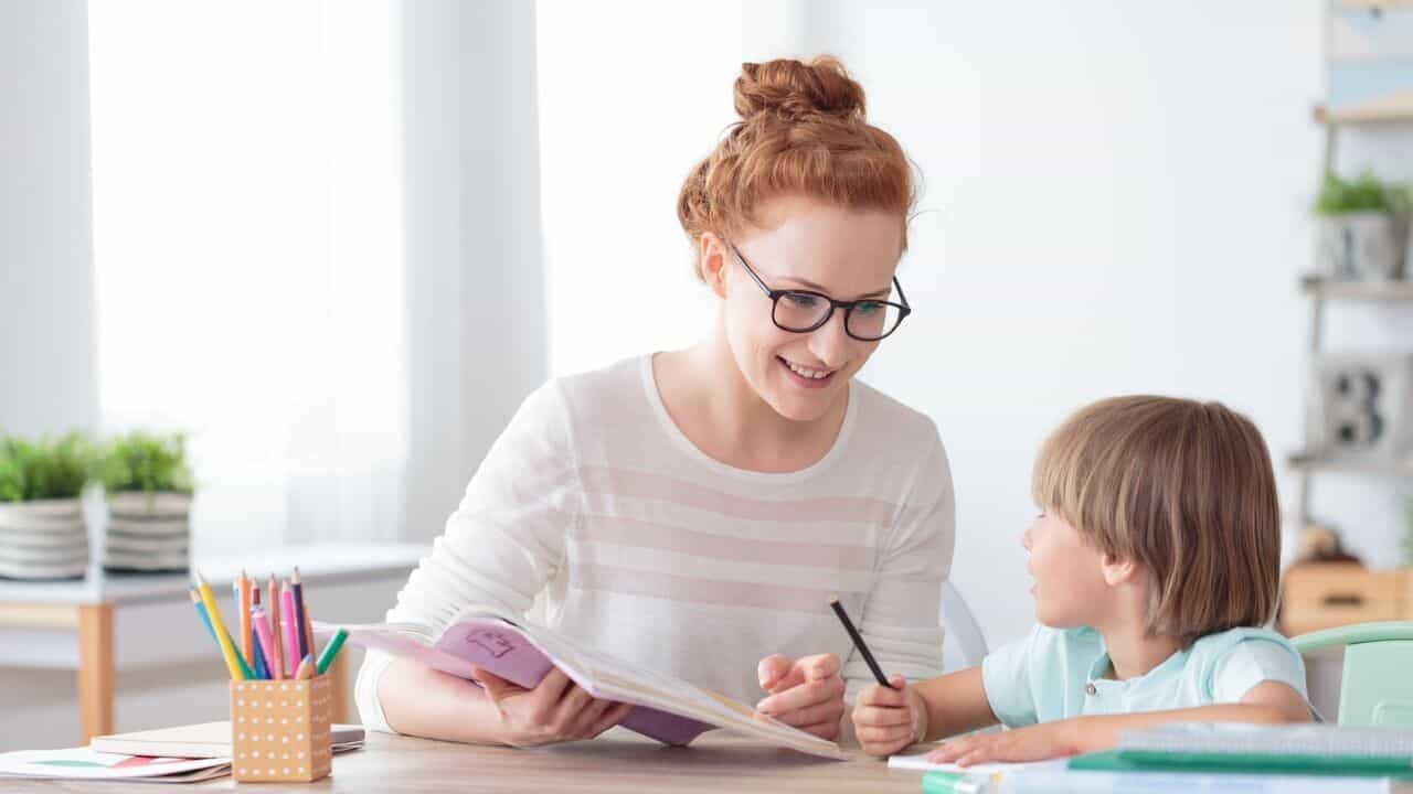 A young child engaging in therapy with a female therapist