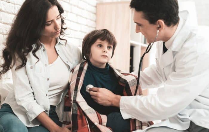 Healthcare professional assessing a young child