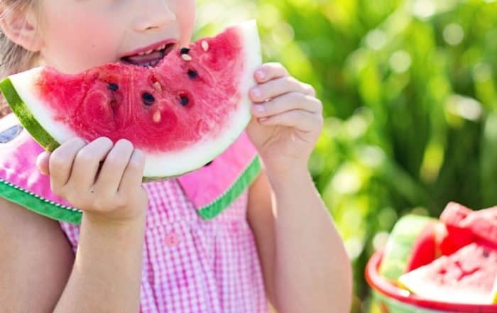 Child enjoying a slice of watermelon