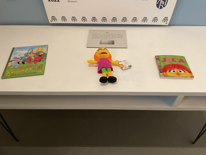 Children's books and a toy placed on a white table