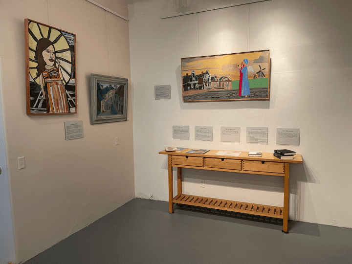 Interior of the National Autism History Museum featuring a painting and a wooden drawer with books